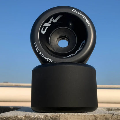 105mm Mad Wheels V2 electric skateboard wheels showing wide 70mm contact patch and front core design in an outdoor setting