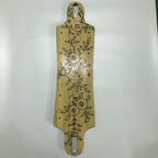 A beige Verreal RS skateboard deck with a floral pattern.
